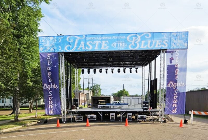 ST315 hydraulic mobile stage fully deployed in downtown Crystal Springs for outdoor community event setup