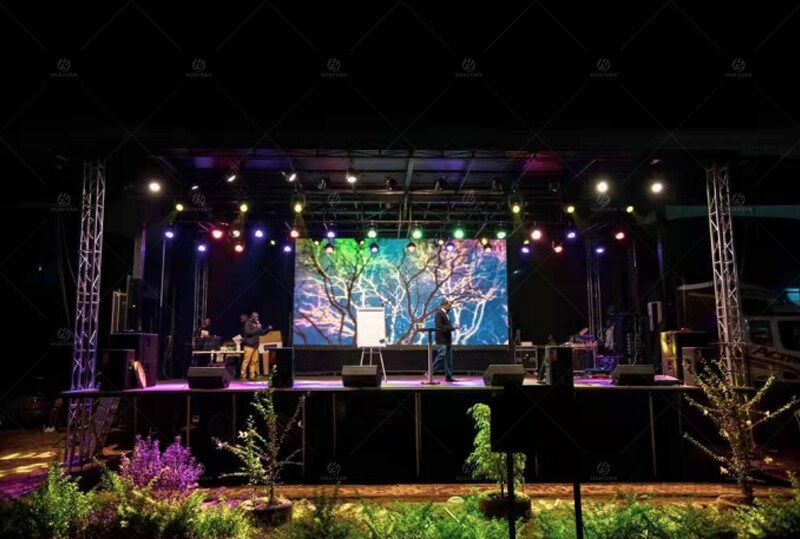 The S455 mobile stage semi-trailer is in operation during a nighttime event in Kampala, Uganda, with the LED display and lighting systems on.